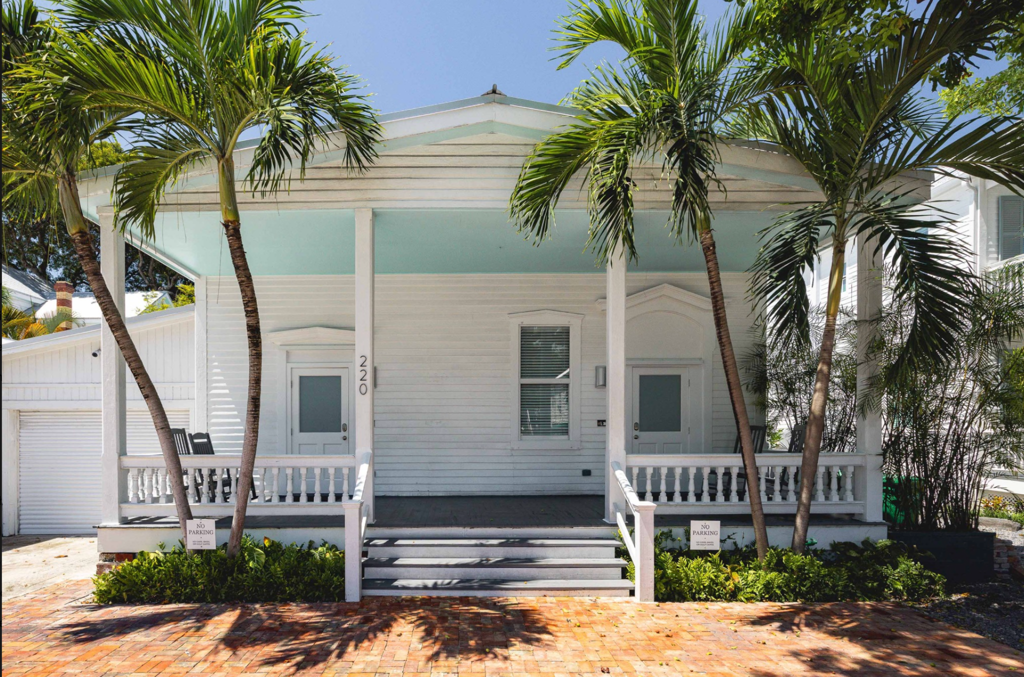 White porch and palm trees at Mesa House